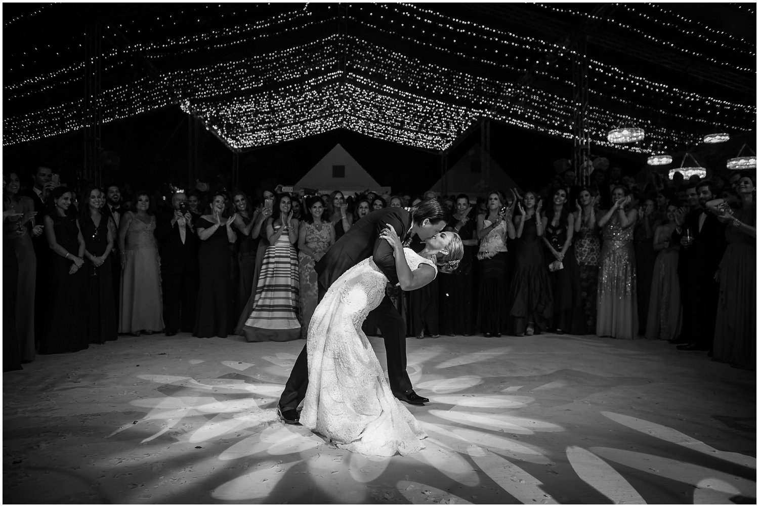 Wedding reception kiss under lights